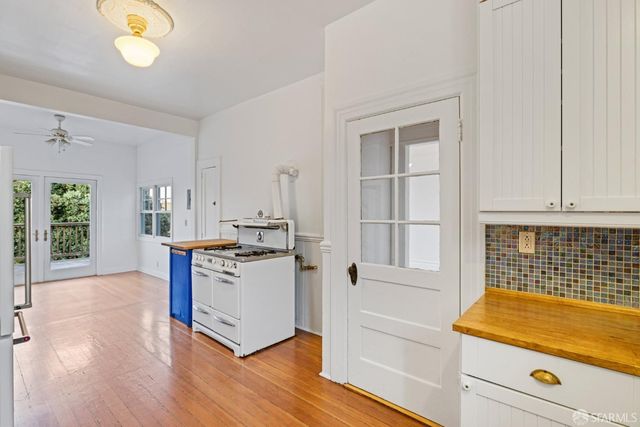 a view of a room with wooden floor and a window