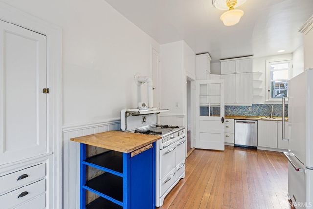 a view of a room with wooden floor