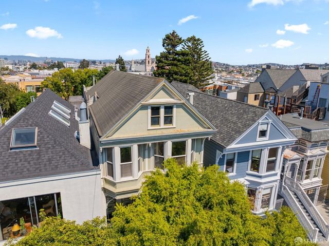 a kitchen with a stove a refrigerator and a wooden floor