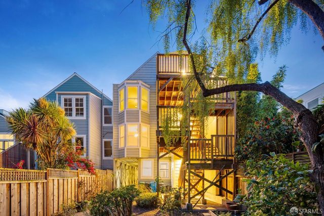 a living room with fireplace and wooden floor