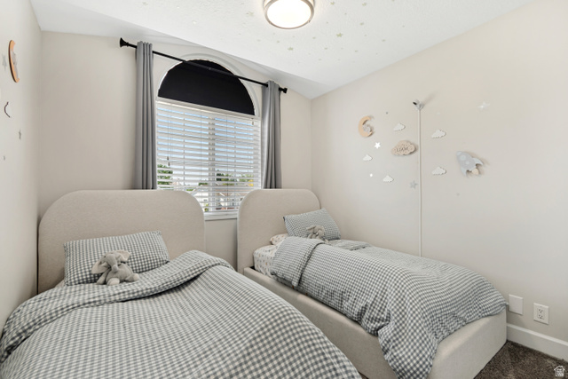 4752 South 4075th Street West Roy, UT 84067 - Photo 13 of 28 Bedroom featuring a large arched window with blinds, a flush mount ceiling light, and light-toned walls