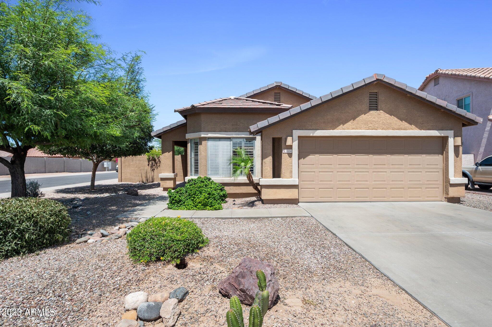 3354 East Bonanza Road Gilbert, AZ 85297 - Photo 1 of 23 a front view of a house with a yard and garage