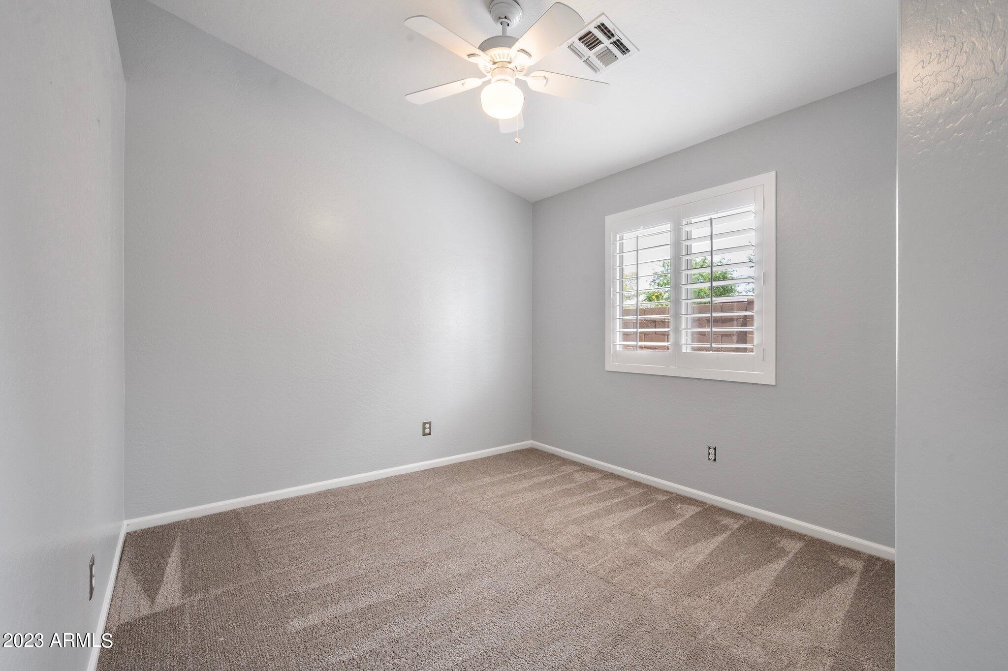 3354 East Bonanza Road Gilbert, AZ 85297 - Photo 17 of 23 an empty room with a window and a fan