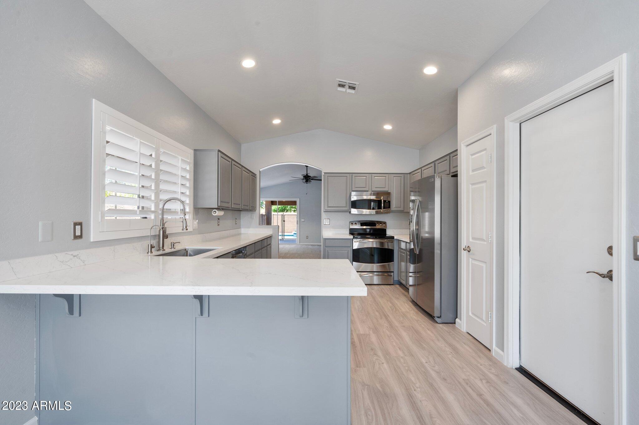 3354 East Bonanza Road Gilbert, AZ 85297 - Photo 6 of 23 a large kitchen with a large counter top appliances and cabinets
