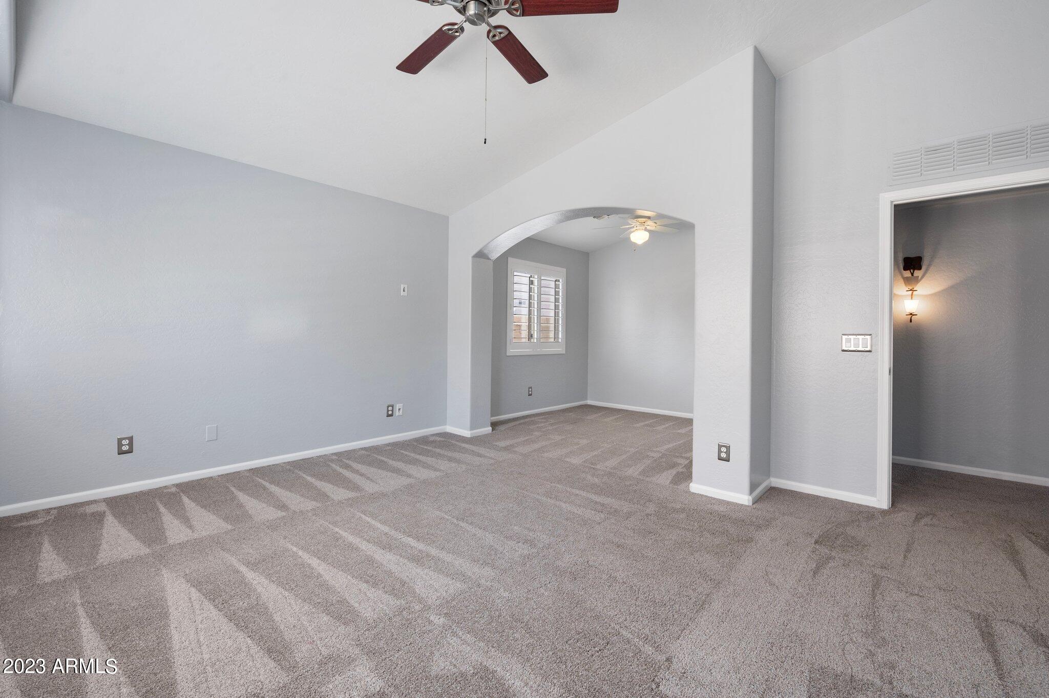 3354 East Bonanza Road Gilbert, AZ 85297 - Photo 9 of 23 a view of an empty room with a ceiling fan