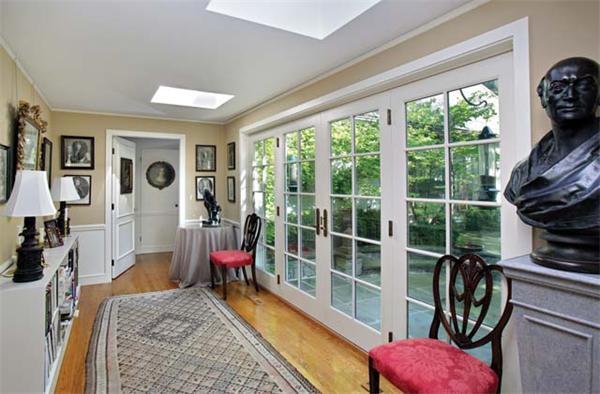 540 Chestnut Hill Avenue Brookline, MA 02445 - Photo 9 of 11 a living room with furniture a flat screen tv and a floor to ceiling window