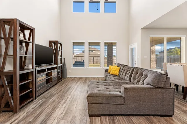 a bedroom with a bed and a flat tv screen on dresser