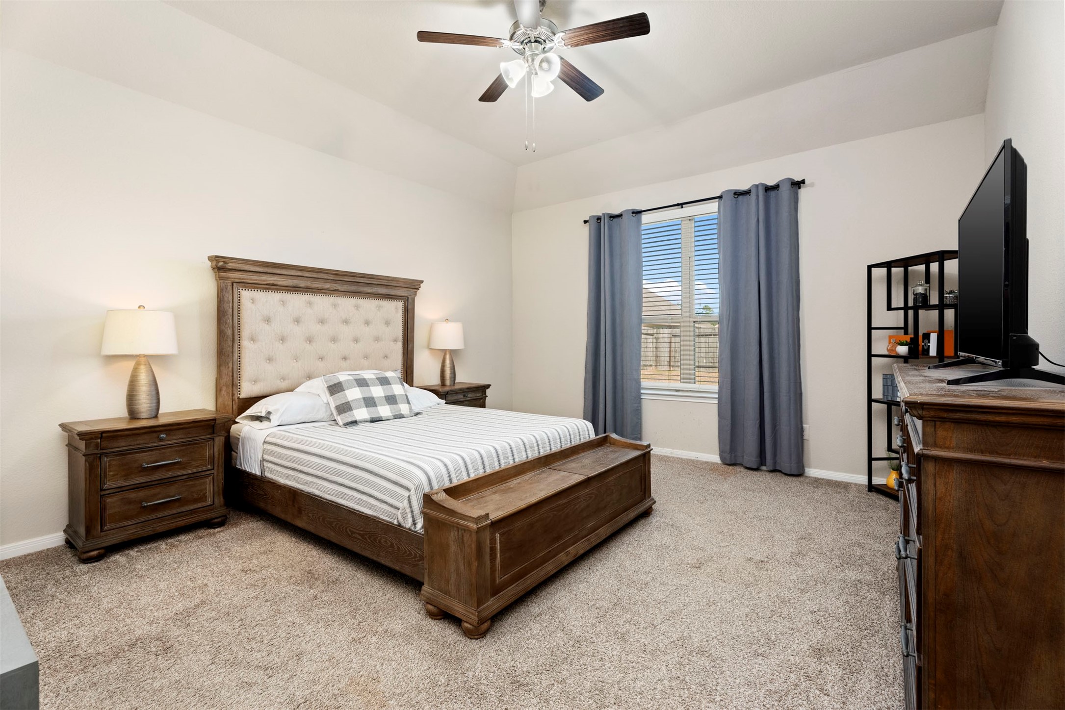 28109 Steepleridge Ct Spring Spring, TX 77386 - Photo 16 of 36 a bedroom with a bed and a flat tv screen on dresser