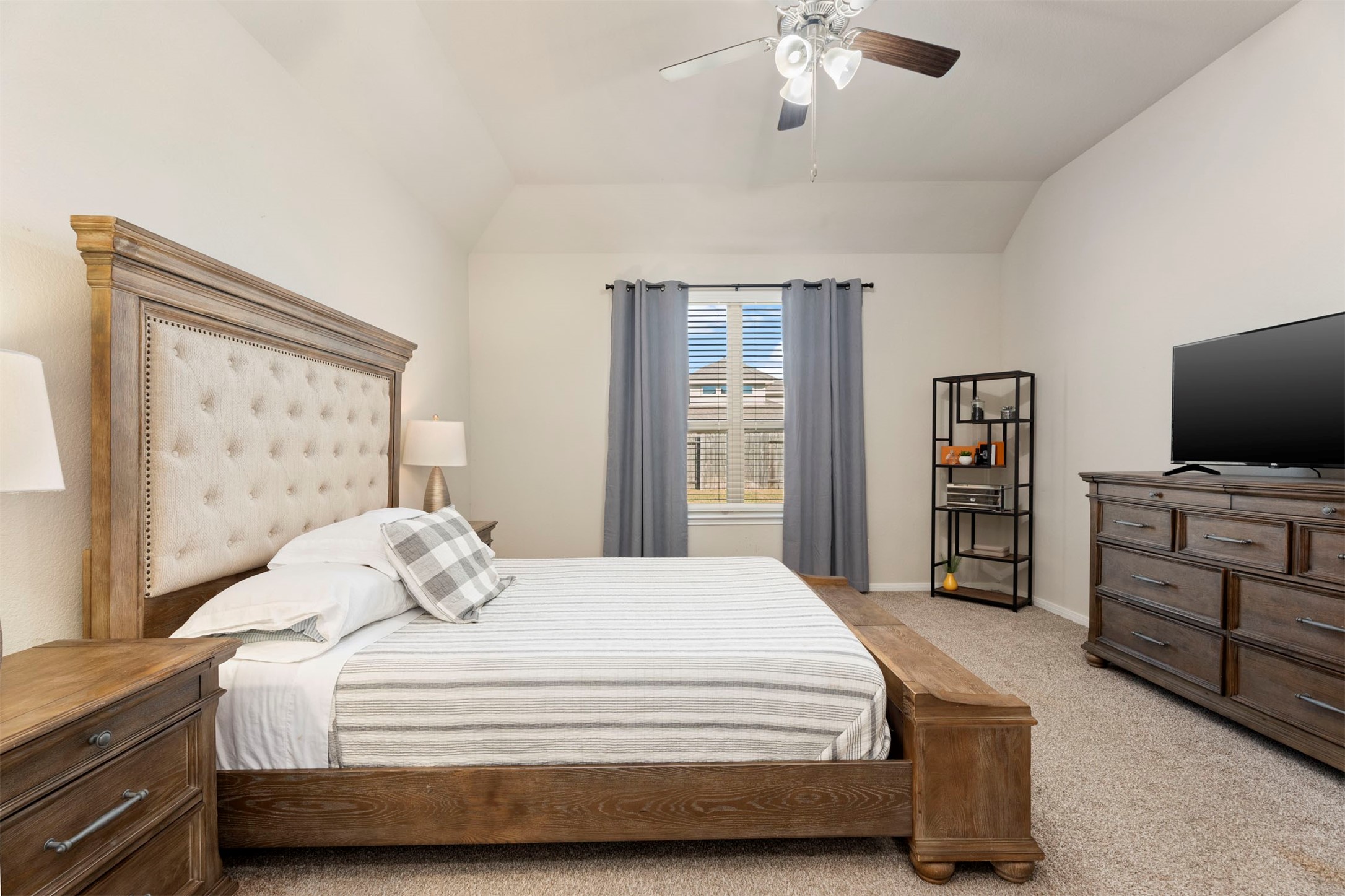 28109 Steepleridge Ct Spring Spring, TX 77386 - Photo 17 of 36 a bedroom with a bed and a flat tv screen on dresser