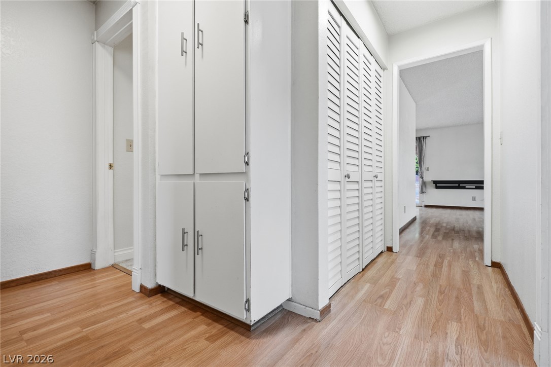 3971 Spring Leaf Drive Las Vegas, NV 89147 - Photo 17 of 48 Functional hallway storage and seamless wood-look flooring enhance this inviting interior space.