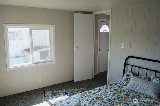 a bedroom with a bed and a window