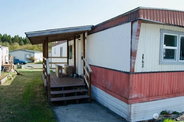 a wooden bench sitting in front of a house