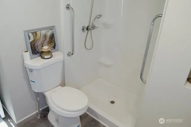 a bathroom with a toilet and a shower