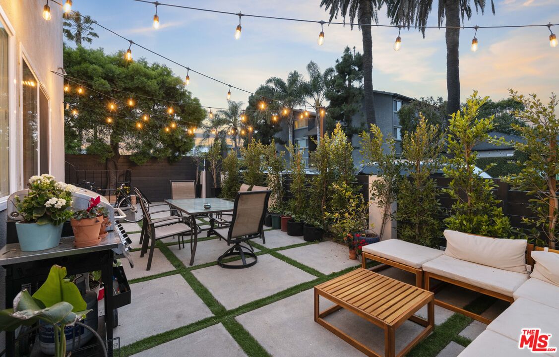 656 Indiana Avenue, Unit 2 Venice, CA 90291 - Photo 11 of 14 a view of a patio with table and chairs potted plants and palm tree