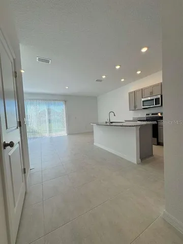a kitchen with stainless steel appliances a refrigerator and a sink