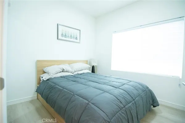 a large bed sitting in a bedroom next to a window