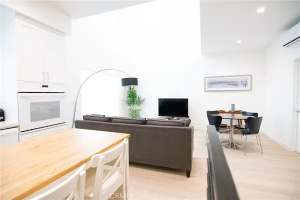 a living room with stainless steel appliances kitchen island granite countertop furniture and a kitchen view