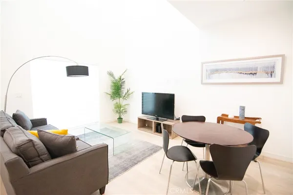 a kitchen with stainless steel appliances kitchen island granite countertop a sink a stove and white cabinets