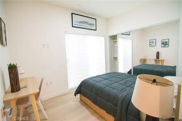 a bedroom with a bed and chair