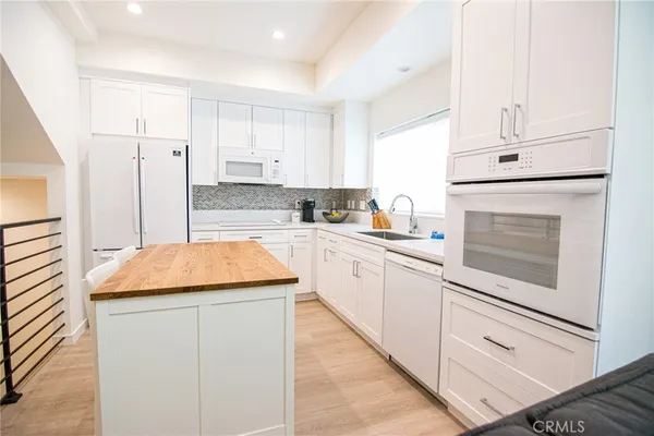 a kitchen with a stove a sink and a refrigerator
