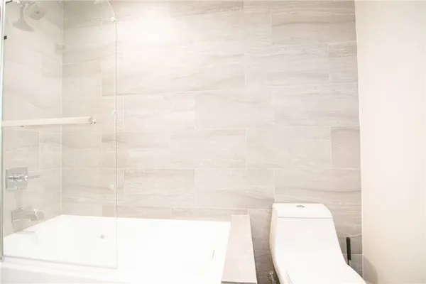 a bathroom with a bathtub and a toilet