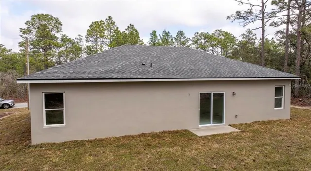 a backyard of a house with yard fire pit and outdoor seating