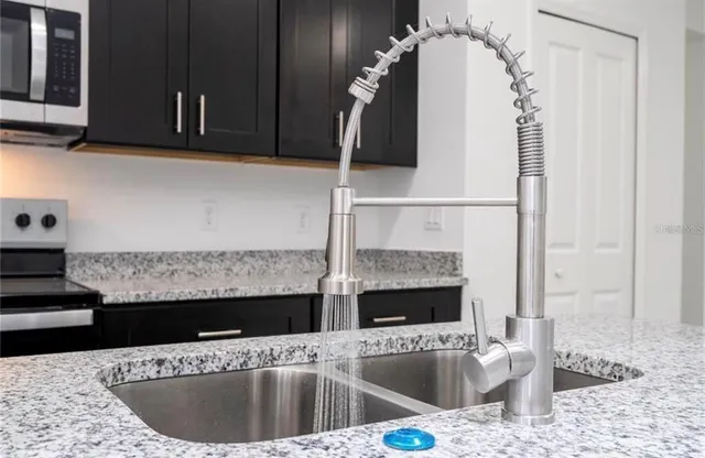 a kitchen with granite countertop stainless steel appliances and cabinets
