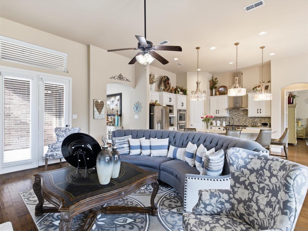 13788 El Toro Road Frisco, TX 75035 - Photo 14 of 29 Living room featuring arched walkways, dark wood-type flooring, a ceiling fan, and recessed lighting