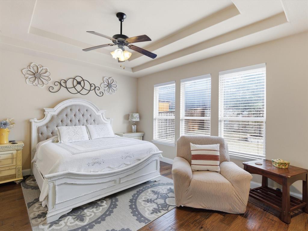 13788 El Toro Road Frisco, TX 75035 - Photo 25 of 29 Bedroom featuring hardwood / wood-style flooring, ceiling fan, and a tray ceiling