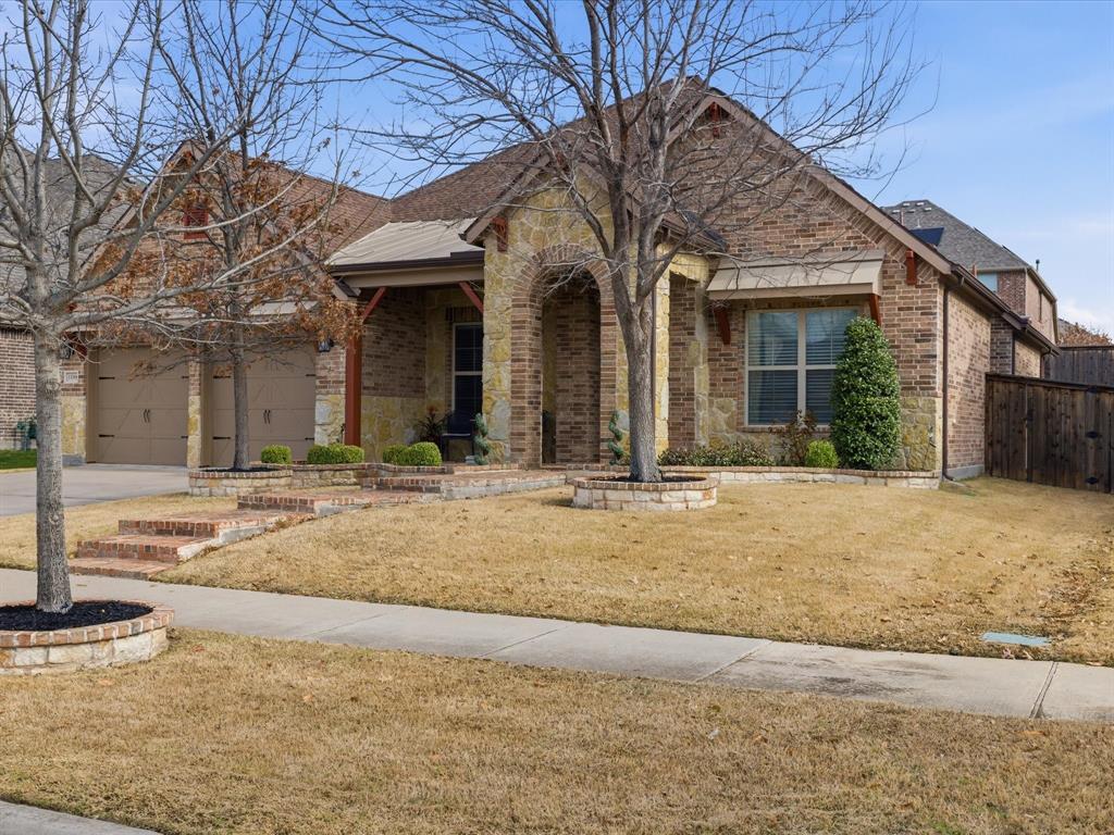 13788 El Toro Road Frisco, TX 75035 - Photo 6 of 29 View of front facade with brick siding, covered porch, concrete driveway, stone siding, and a garage