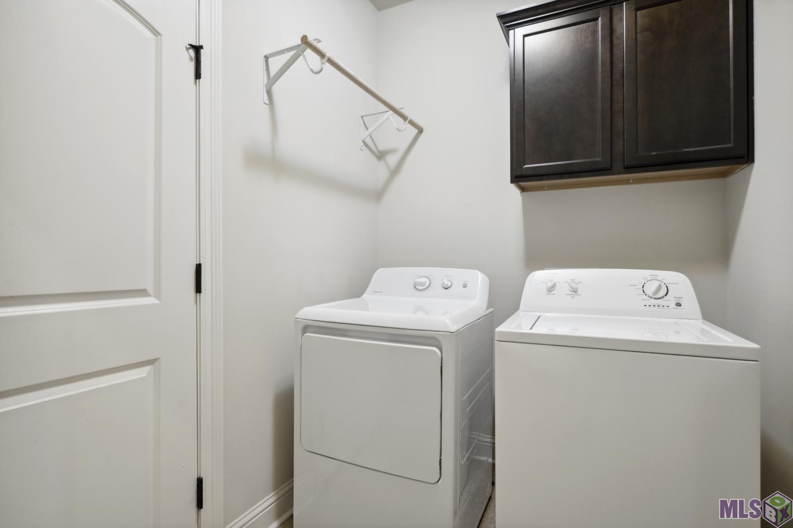 9426 Falling Oak Drive Baton Rouge, LA 70817 - Photo 22 of 25 Laundry Room with Cabinets & Hanging Rack