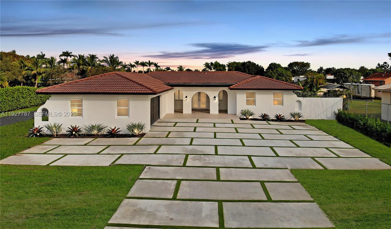 a front view of a house with a garden