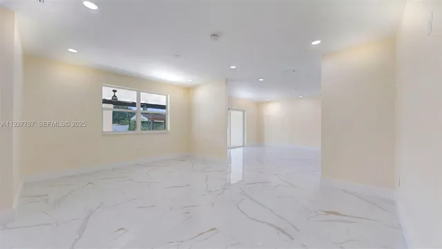 a kitchen with kitchen island granite countertop a sink a counter top space appliances and cabinets