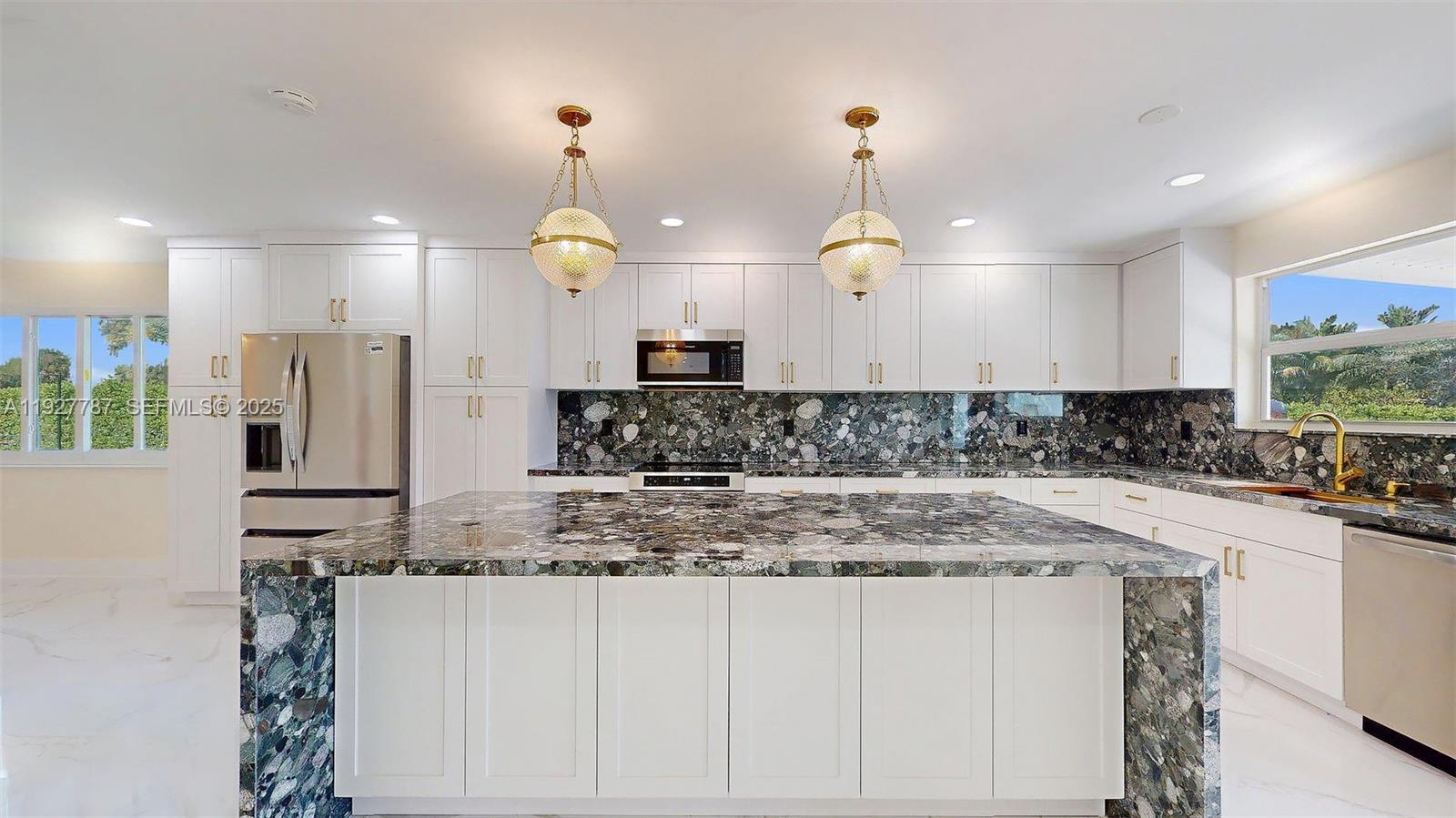 3801 Southwest 132nd Avenue Miami, FL 33175 - Photo 20 of 74 a kitchen with kitchen island granite countertop a stove a sink a refrigerator and white cabinets with wooden floor