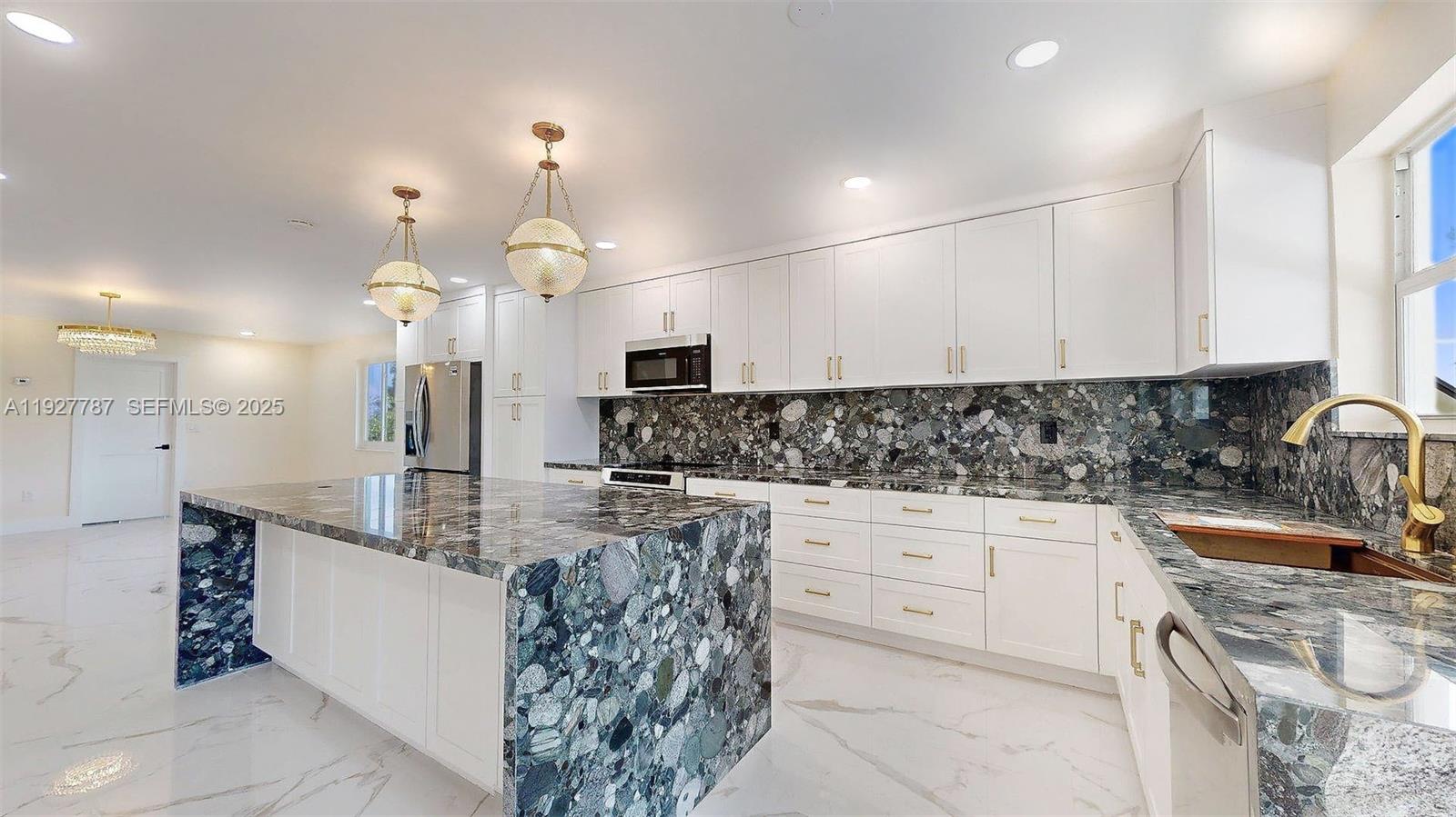 3801 Southwest 132nd Avenue Miami, FL 33175 - Photo 21 of 74 a kitchen with kitchen island granite countertop a sink a counter top space appliances and cabinets