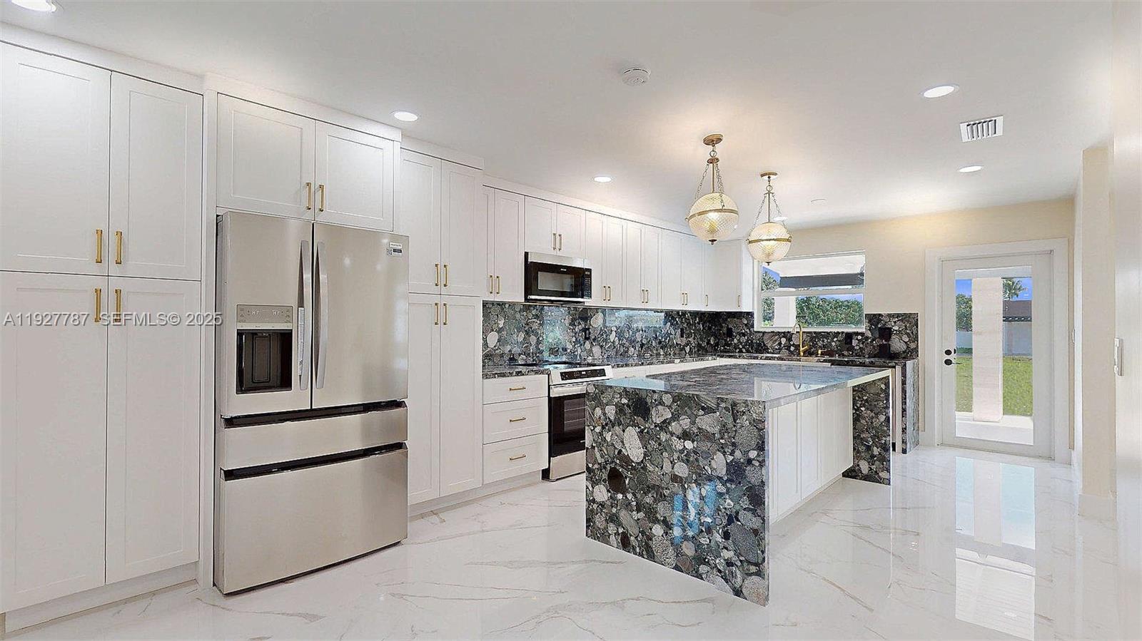 3801 Southwest 132nd Avenue Miami, FL 33175 - Photo 24 of 74 a large kitchen with stainless steel appliances kitchen island a sink and a refrigerator
