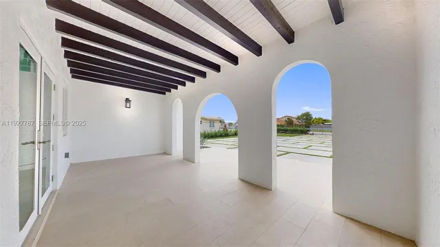 a view of a hallway with wooden floor and windows