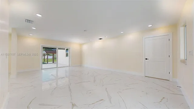 a view of a big room with closet and windows