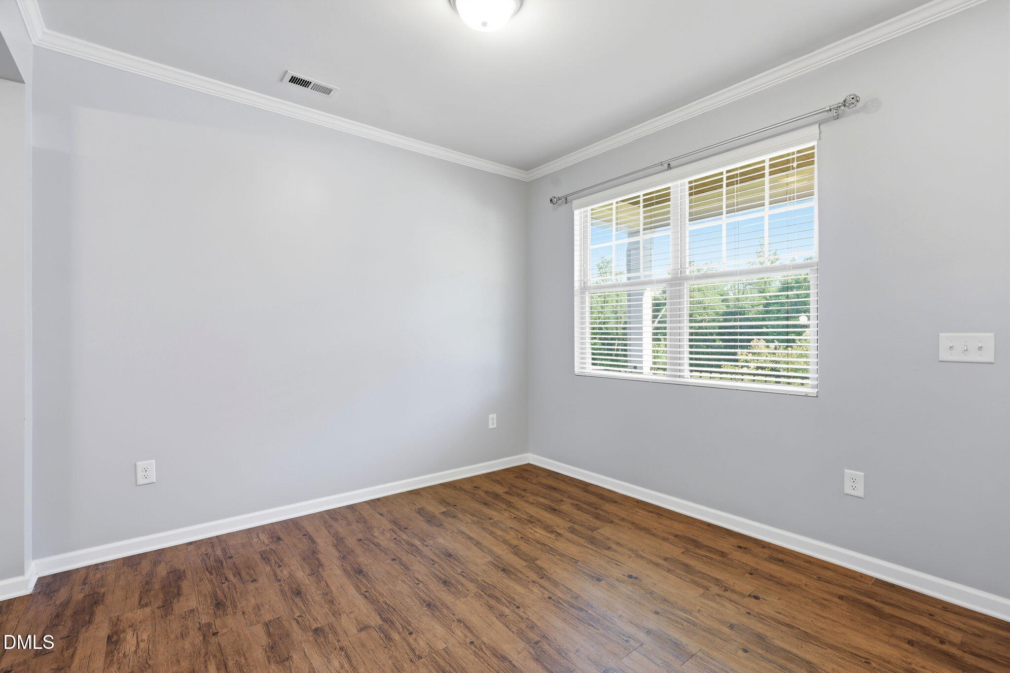 1808 Austin Rdg Parkway Wake Forest, NC 27587 - Photo 9 of 57 a view of an empty room with wooden floor and a window