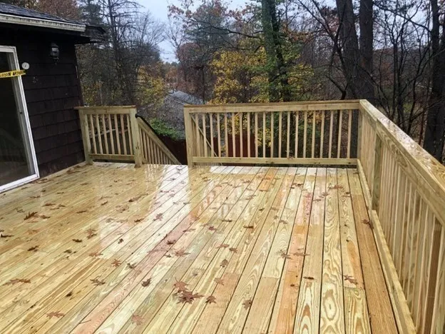 a view of backyard with wooden floor and fence