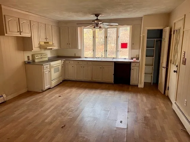 a kitchen with stainless steel appliances a refrigerator and a stove
