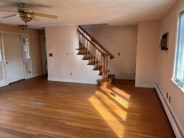 a view of a room with wooden floor and staircase