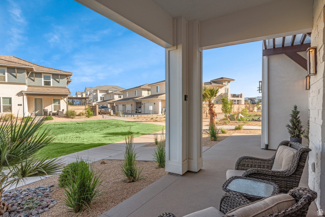 5367 Cyan Lane St. George, UT 84790 - Photo 41 of 49 Covered patio featuring concrete flooring and stone veneer accent wall