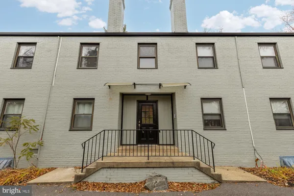 a view of a brick house with many windows