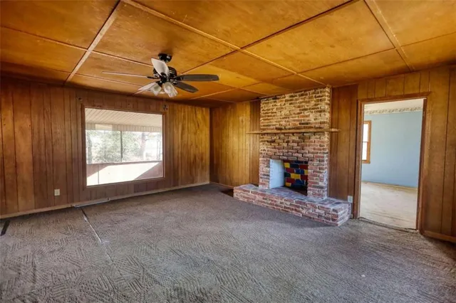 a view of a livingroom with a fireplace and window