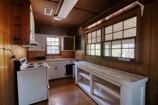 a kitchen that has a sink and a stove in it