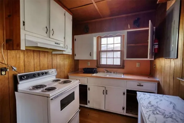 a kitchen with a stove and a sink