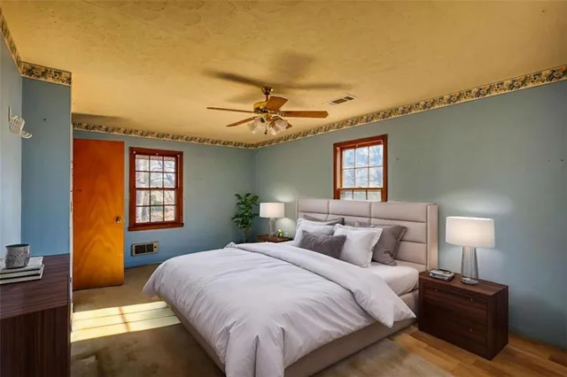 a bedroom with a bed and a night stand