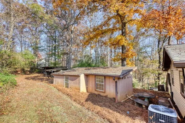 a view of a bench in the backyard of the house