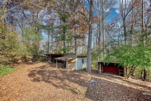 a backyard of a house with table and chairs